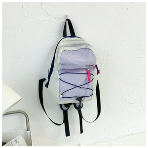 Detail of color-block mini backpack with purple panel and neon pink zipper pullers