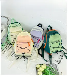 Detail showing four vibrant nylon drawstring backpacks in diverse color-block designs