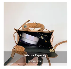 Internal capacity of brown mini bear handbag showing small cosmetic items inside