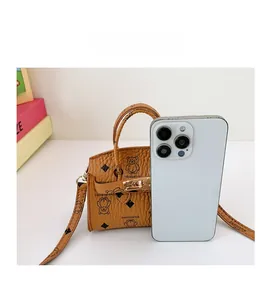 Size comparison of mini cartoon bear shoulder bag with a smartphone for scale