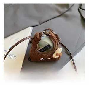Detail view of the plush bucket bag interior showing capacity for cosmetics and accessories