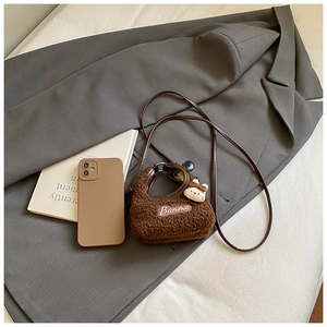 Detail of brown teddy fleece mini crossbody bag with Banma embroidery and cute rabbit charm