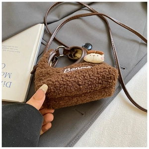 Detail of brown plush crossbody bag with cute teddy bear and Banma embroidery