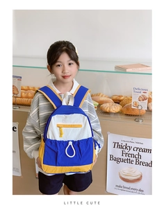 Close-up of kids backpack featuring contrast colors, drawstring pocket and cute lettering