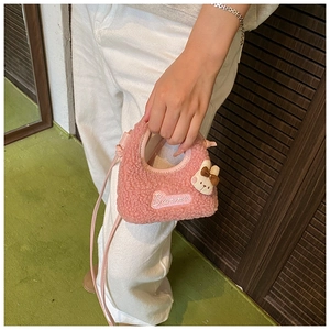 Detailed close-up of pink plush bunny bag with Banmi embroidery and soft lamb wool texture