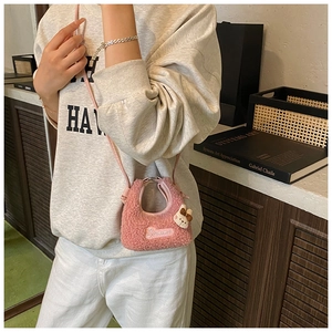 Detail of pink plush crossbody bag with Barbie embroidery and cute rabbit charm
