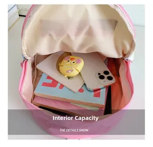Internal capacity view of pink school backpack showing storage for phone and notebooks