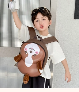 Detail of a brown 3D animal-shaped EVA hard shell toddler backpack worn by a child
