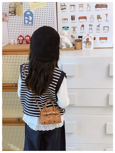 Detail of kids mini shoulder bag with cartoon bear prints and metal twist lock closure