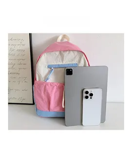 Detailed comparison of color-block school backpack showing tablet and phone capacity size