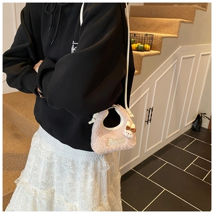 Pink plush rabbit mini shoulder bag shown on a model for casual daily outfit style