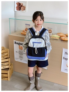 Detail of kids school backpack showing tricolor stitching and durable drawstring pocket
