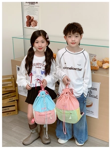 Vue détaillée de sacs à dos à cordon colorés pour enfants dans un décor de boulangerie