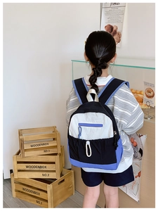 Detailed back view of a color-block school backpack with large capacity and nylon texture