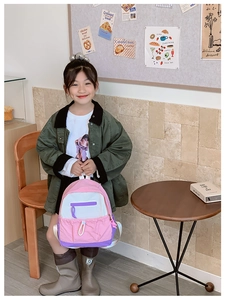 Close-up of pink and purple waterproof nylon backpack with side pockets for kids