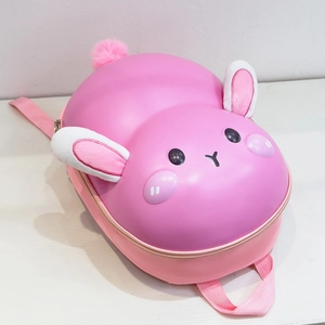 Detail view of pink bunny hard shell kids backpack with plush ears and woven straps