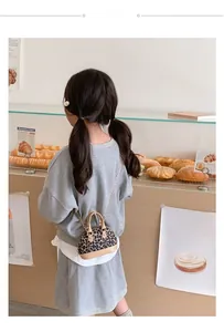 Macro detail of kids leopard print shell bag with golden chain and handle