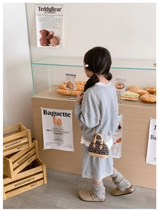 Girl's stylish grey sweatshirt outfit styled with a leopard print mini shell chain bag