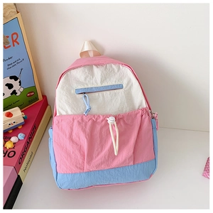 Detail view of the pink, blue, and white patchwork nylon backpack for students