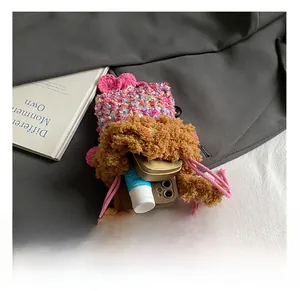 Capacité interne du sac monstre en tricot rose montrant le rangement du maquillage