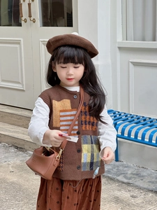 Brown knit vest paired with a polka dot skirt and matching beret for kids' fashion