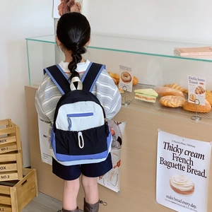 Modern color-block school backpack for kids with wide straps in blue white and black