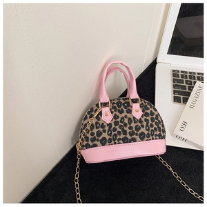 Detailed view of leopard print mini shell bag with pink leather trim and gold chain