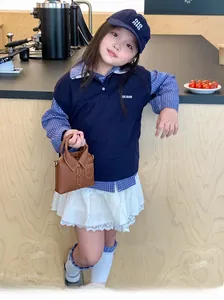 Close-up of stylish brown shirt-shaped crossbody bag and girl's knit vest outfit