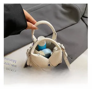 Macro view of white textured mini bag interior showing capacity and blue stitching detail