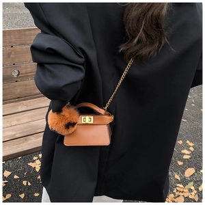 Mini caramel leather crossbody bag with fluffy pompom and gold chain strap