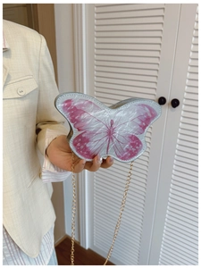 Close-up of a sweet butterfly-shaped mini bag for girls with a gold metal chain strap