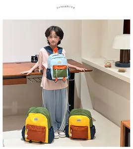 Detail view of colorful dual-tone school backpacks with mesh side pockets and front zip
