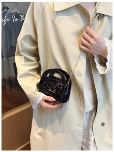 Vue détaillée du sac bandoulière en cuir verni noir avec nœud pour fillettes