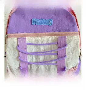 Close-up of color-block kids backpack with purple drawstring and brand logo detail