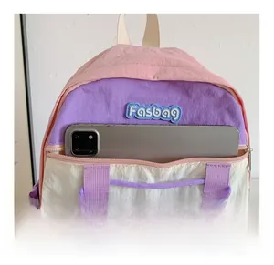 Detailed front pocket storage of the color-block nylon backpack with a tablet inside