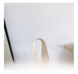 Detail of the pink gradient backpack showing the durable cream nylon webbing handle