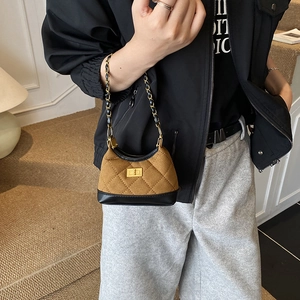 Quilted mini crossbody bag with gold chain and turn-lock closure in matte brown