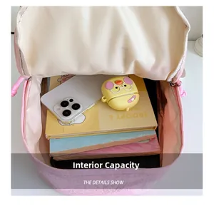 Spacious interior of pink gradient backpack showing storage for school books and tablet