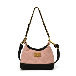 Pink quilted crossbody bag for kids with gold chain handle and vintage lock on white backdrop