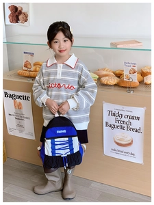 Detail of kids casual backpack with blue drawstring design in a bakery setting