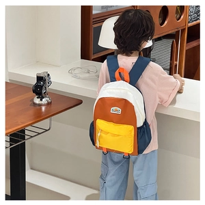 Detail of color-block kids backpack with sun patch and adjustable shoulder straps