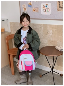 Detail of colorful rainbow patch embroidery on pink and white school backpack for girls