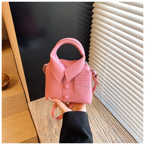 Close-up of pink mini shirt-shaped bag featuring pebble grain texture and button details
