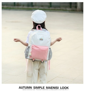 Detailed back view of kids' color-block backpack showing pink straps and side pockets