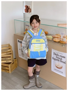 Detailed view of kids backpack with elastic drawstring and vibrant color blocking