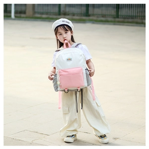 Detailed view of kids' color-block backpack showing pink straps and side pocket stitching