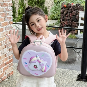 Detail of pink 3D unicorn backpack for toddlers shown worn by a girl outdoors