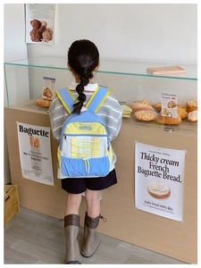 Detail of kids color-block backpack with drawstring design and waterproof nylon texture