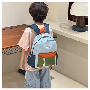 Detail of colorful nylon kids backpack with mountain patch and adjustable straps