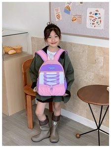 Detail of the purple and pink contrast children's backpack with drawstring on a young girl